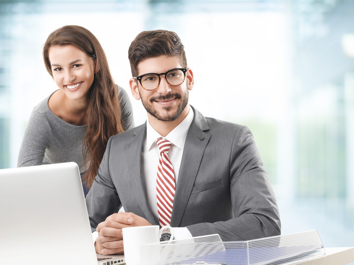Consultants reviewing a client's reporting requirements together