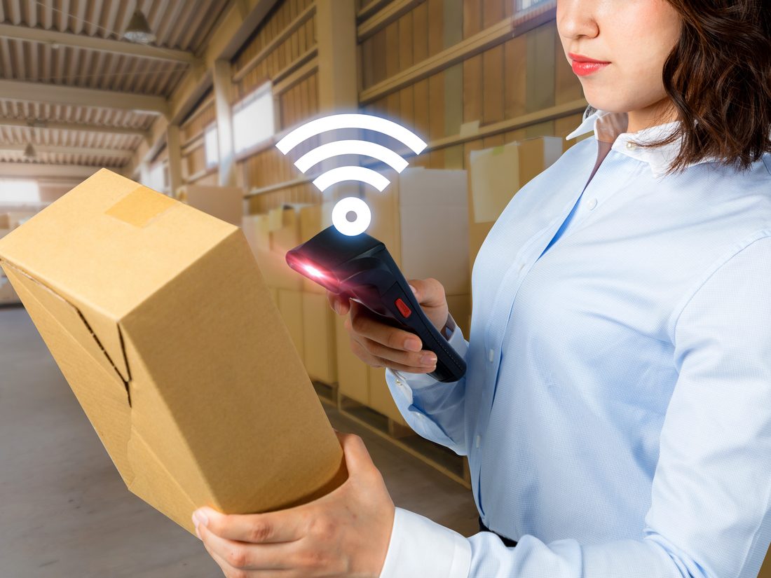 Warehouse operator scanning a carton to update stock in real time